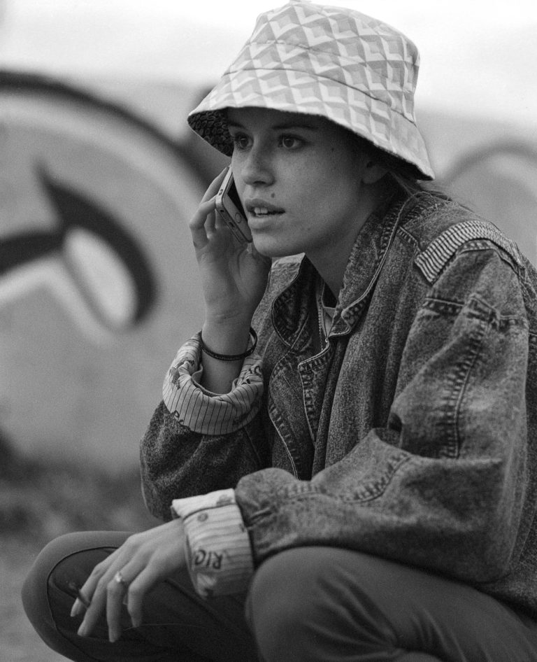black and white film portrait of girl with a phone